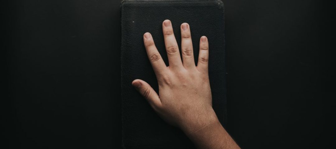 man-touching-book-2258252